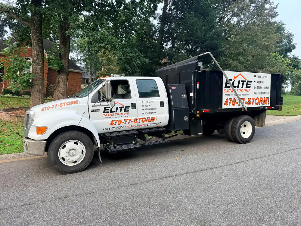 Elite Catastrophe storm response truck and debris trailer on a neighborhood street
